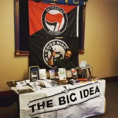 The Big Idea Tabling at an event with Antifa flags